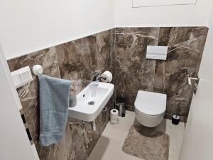 a bathroom with a sink and a toilet at Apartmán Meridiem Komárovská in Komárov +4 photos