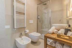 a bathroom with a toilet and a sink and a shower at La Corte del Lario - La Cortesella in Varenna