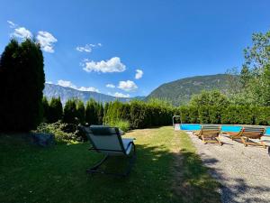 a yard with two chairs and a swimming pool at Haus Dorothee in Sautens