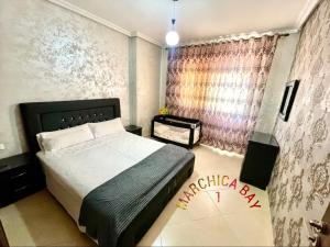 a bedroom with a large bed and a window at Marchica Bay 1 holiday Apartment in Nador +6 photos