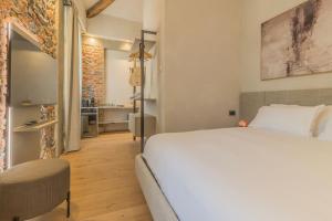 a bedroom with a large white bed and a bathroom at La Corte Del Lario - San Giorgio in Varenna