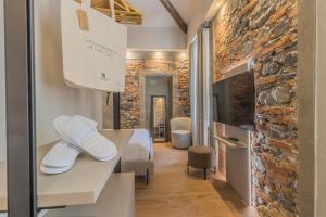 a room with a bed and a stone wall at La Corte Del Lario - San Giorgio in Varenna