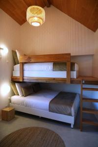 a bedroom with two bunk beds and a table at Casa do Ti Maurício in Gondemaria
