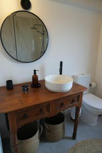 a bathroom with a sink and a mirror on a table at Casa do Ti Maurício in Gondemaria +34 photos