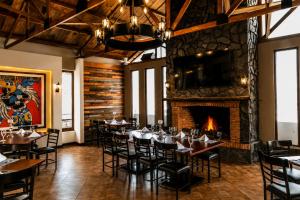 a dining room with tables and chairs and a fireplace at Hotel Cacaxtla Collection in Tlaxcala de Xicohténcatl