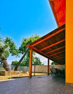 a wooden pavilion with a table and chairs on a patio at Casa Buonanotte in San Marco di Castellabate