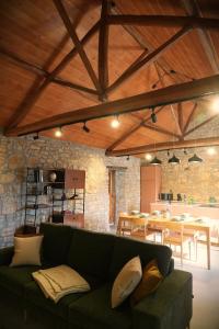 a living room with a green couch and a table at Casa do Ti Maurício in Gondemaria