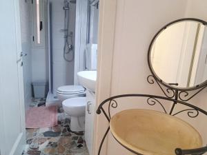 a bathroom with a sink and a mirror on the wall at S'erribera de S'abiolu in Baunei +6 photos