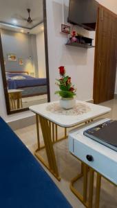 a table with a plant on it in a room at Pearl Haven in Jorhat