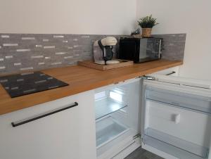 a kitchen with a counter top with a microwave at Les Nuits Nordiques in Bras +13 photos