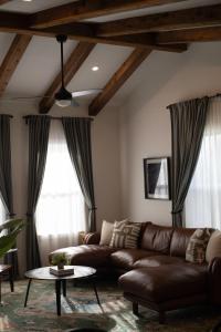 a living room with a leather couch and a table at Orion B, Vaulted Ceilings, Pool, Bunk Room in Port Isabel