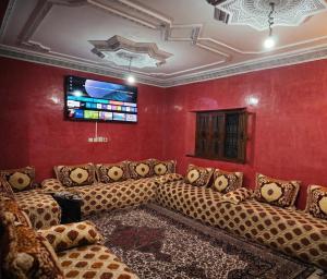 a room with couches in a room with red walls at Villas khadija in Marrakesh