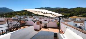 a white umbrella sitting on top of a balcony at El Mirador del Asno in El Bosque