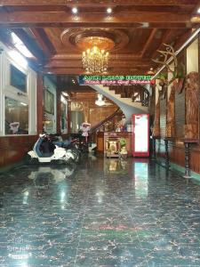 a lobby with a room with a motorcycle on the floor at Hottel ANH LONG in Buôn Ðũng