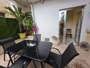a patio with a table and chairs and a couch at Sicilia Mount&Sea in Mascali