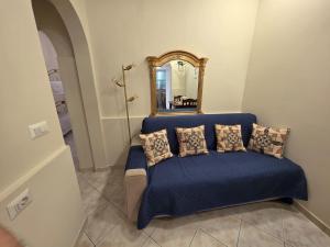 a blue couch with pillows in front of a mirror at Sicilia Mount&Sea in Mascali
