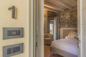 a bedroom with a king sized bed in a room at La Corte del Lario - Contrada dei Sarti in Varenna +4 photos