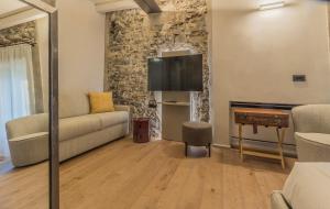 a living room with a couch and a flat screen tv at La Corte del Lario - Contrada dei Sarti in Varenna