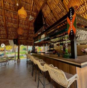 a bar in a restaurant with chairs and a counter at Hotel Four20 Zensi - Meta in Lejanías