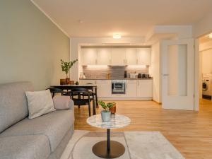 a living room with a couch and a table at Limehome Dresden Wallstraße - Digital Access in Dresden +60 photos