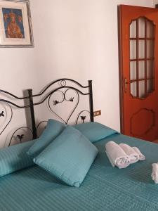 a bed with two pillows on top of it at Il Castello in Viggiano