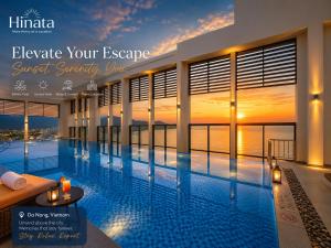 a large swimming pool with a sunset in the background at Luxury Apartment - Rooftop Swimming Pool - Beach Front - Hinata Apartment in Danang