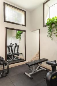 a gym with two mirrors and two exercise bikes at Hotel Diocleziano in Rome +38 photos