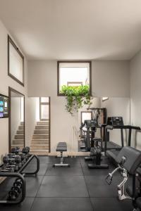 a gym with treadmills and exercise equipment and a window at Hotel Diocleziano in Rome