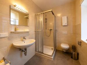 a bathroom with a shower and a sink and a toilet at Kulturhotel Kaiserhof in Bad Liebenstein +40 photos