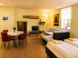 a living room with a couch and a table at Kulturhotel Kaiserhof in Bad Liebenstein