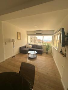 a living room with a couch and a table at Apartmani Paula in Makarska