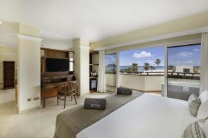 a bedroom with a bed and a view of the ocean at Barceló Corralejo Bay - Adults Only in Corralejo
