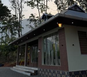 a building with a window on the side of it at Riverfolk Stays in Thodupuzha