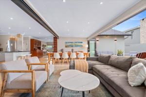 a living room with a couch and a table at 8 on Nivenia in Bettyʼs Bay