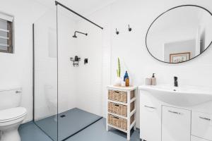 a bathroom with a toilet sink and a mirror at 8 on Nivenia in Bettyʼs Bay +49 photos