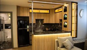 a kitchen with a counter and a couch in a room at كمبوند العالمية in Madinat Al Ashir min Ramadan