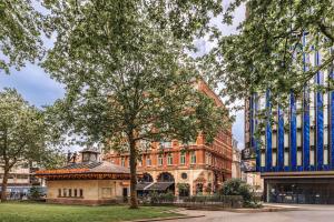 a building with a tree in front of it at Radisson Blu Hotel, London Leicester Square in London