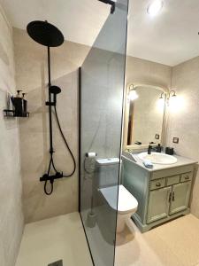a bathroom with a shower and a toilet and a sink at Es Cantonet in Calvià +5 photos