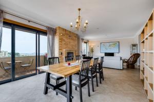 a dining room and living room with a table and chairs at Algarve 360º Experience in Loulé