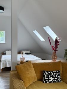 a living room with a couch and a bed at Pro Home Mara private Sauna in Bad Oeynhausen