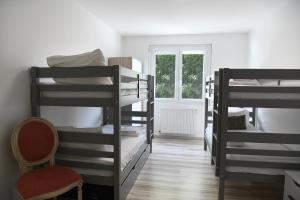 a dorm room with four bunk beds and a window at Domaine familial, Le Parc de Gouts in Aiguillon +37 photos
