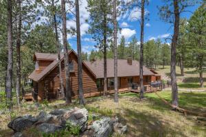 a log cabin in the woods with trees at Tatanka Hideaway Hot Tub Pool Table Massive Space in Custer