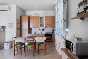 a kitchen with a table and chairs in a room at Le Crapare in Muro Leccese