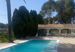 a villa with a swimming pool and a house at Hotel Masía de Altea in Altea