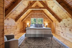 a bedroom with a bed in a wooden cabin at County Line Cabin in Woodland Beach