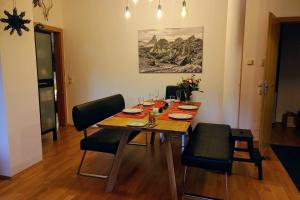 a dining room with a wooden table and chairs at Kerstin 10 in Rauris