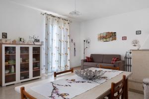 a living room with a table and a couch at Le Crapare in Muro Leccese