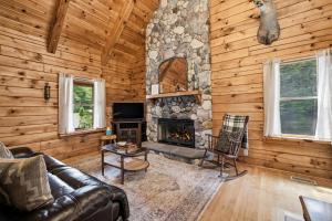 a living room with a couch and a fireplace at County Line Cabin in Woodland Beach +29 photos