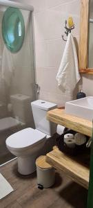 a bathroom with a toilet and a sink at Cabana Refúgio do Hobbit-Gramado @refugiodohobbit in Gramado +34 photos