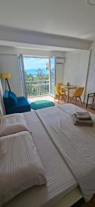 a large white bed in a bedroom with a balcony at Krkulj Apartments in Ohrid